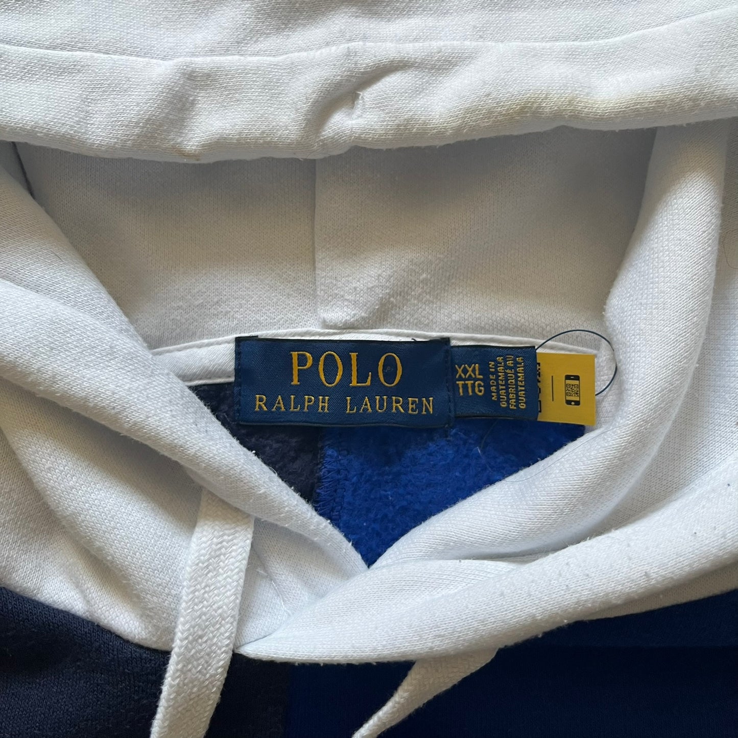 Polo Ralph Lauren x Fortnite 2022 Hoodie featuring a two-tone split design in blue and navy with a white hood. The front showcases a large white panel with “2022” text, Ralph Lauren Est. 1967 branding, and a Fortnite logo, along with an oversized embroidered Polo logo above. A limited collaboration piece combining Ralph Lauren’s heritage aesthetic with Fortnite’s playful edge.