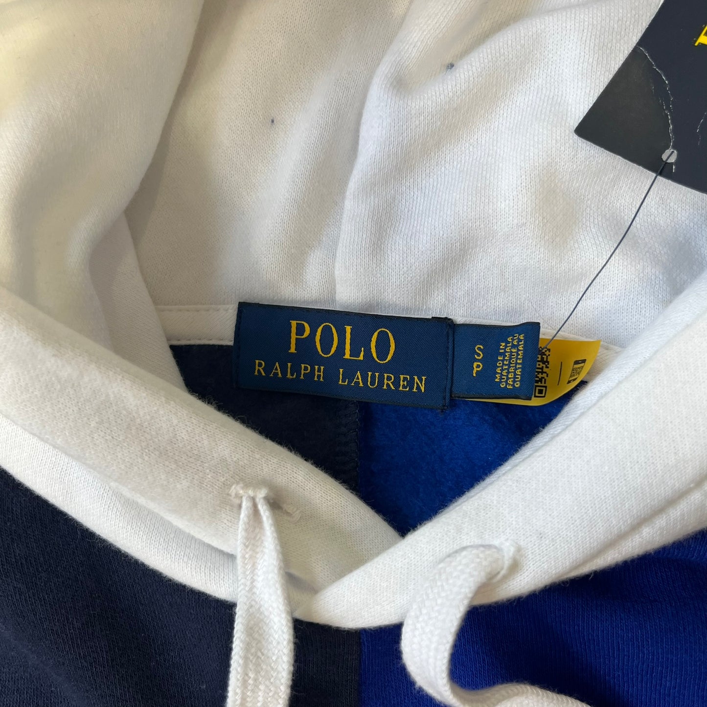 Polo Ralph Lauren x Fortnite 2022 Hoodie featuring a two-tone split design in blue and navy with a white hood. The front showcases a large white panel with “2022” text, Ralph Lauren Est. 1967 branding, and a Fortnite logo, along with an oversized embroidered Polo logo above. A limited collaboration piece with paper tags.