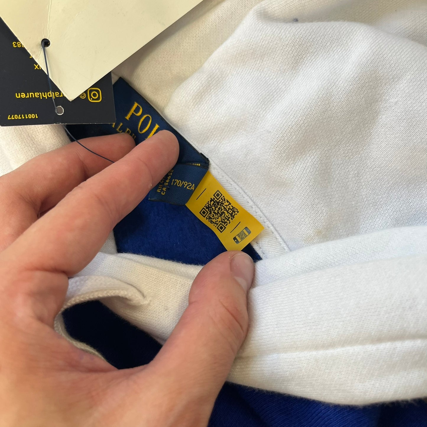 Polo Ralph Lauren x Fortnite 2022 Hoodie featuring a two-tone split design in blue and navy with a white hood. The front showcases a large white panel with “2022” text, Ralph Lauren Est. 1967 branding, and a Fortnite logo, along with an oversized embroidered Polo logo above. A limited collaboration piece with paper tags.