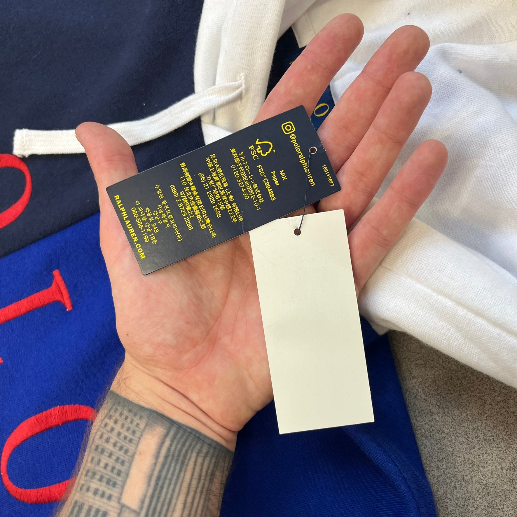 Polo Ralph Lauren x Fortnite 2022 Hoodie featuring a two-tone split design in blue and navy with a white hood. The front showcases a large white panel with “2022” text, Ralph Lauren Est. 1967 branding, and a Fortnite logo, along with an oversized embroidered Polo logo above. A limited collaboration piece with paper tags.