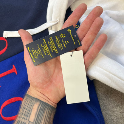 Polo Ralph Lauren x Fortnite 2022 Hoodie featuring a two-tone split design in blue and navy with a white hood. The front showcases a large white panel with “2022” text, Ralph Lauren Est. 1967 branding, and a Fortnite logo, along with an oversized embroidered Polo logo above. A limited collaboration piece with paper tags.