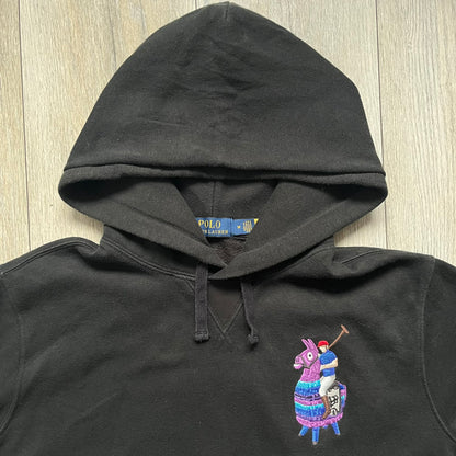 Polo Ralph Lauren x Fortnite black hoodie featuring a detailed embroidered purple Fortnite llama with the RL rider logo placed on top. Made from a 66% cotton and 34% polyester blend, it has a classic pullover construction with an attached hood and front kangaroo pocket. The embroidery is positioned on the left chest and stands out with clean stitching and sharp detail.