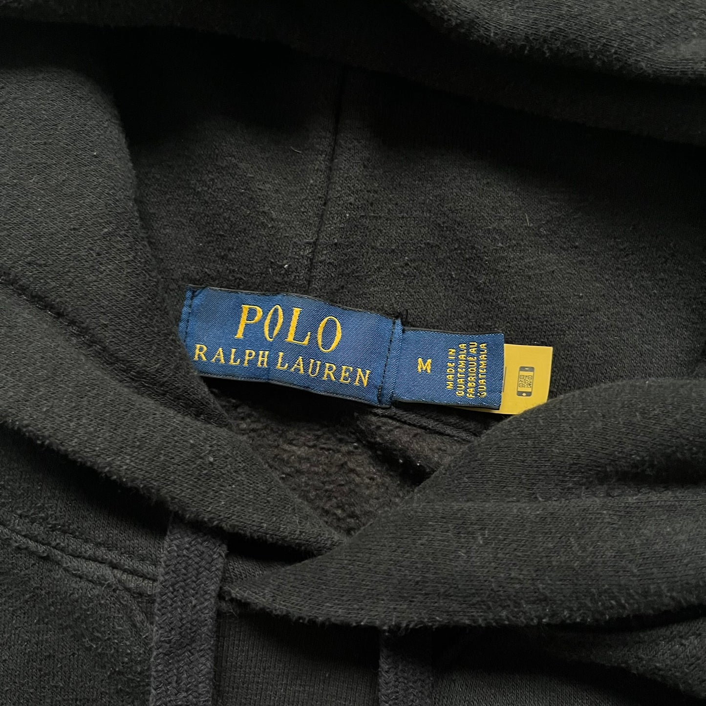 Polo Ralph Lauren x Fortnite black hoodie featuring a detailed embroidered purple Fortnite llama with the RL rider logo placed on top. Made from a 66% cotton and 34% polyester blend, it has a classic pullover construction with an attached hood and front kangaroo pocket. The embroidery is positioned on the left chest and stands out with clean stitching and sharp detail.