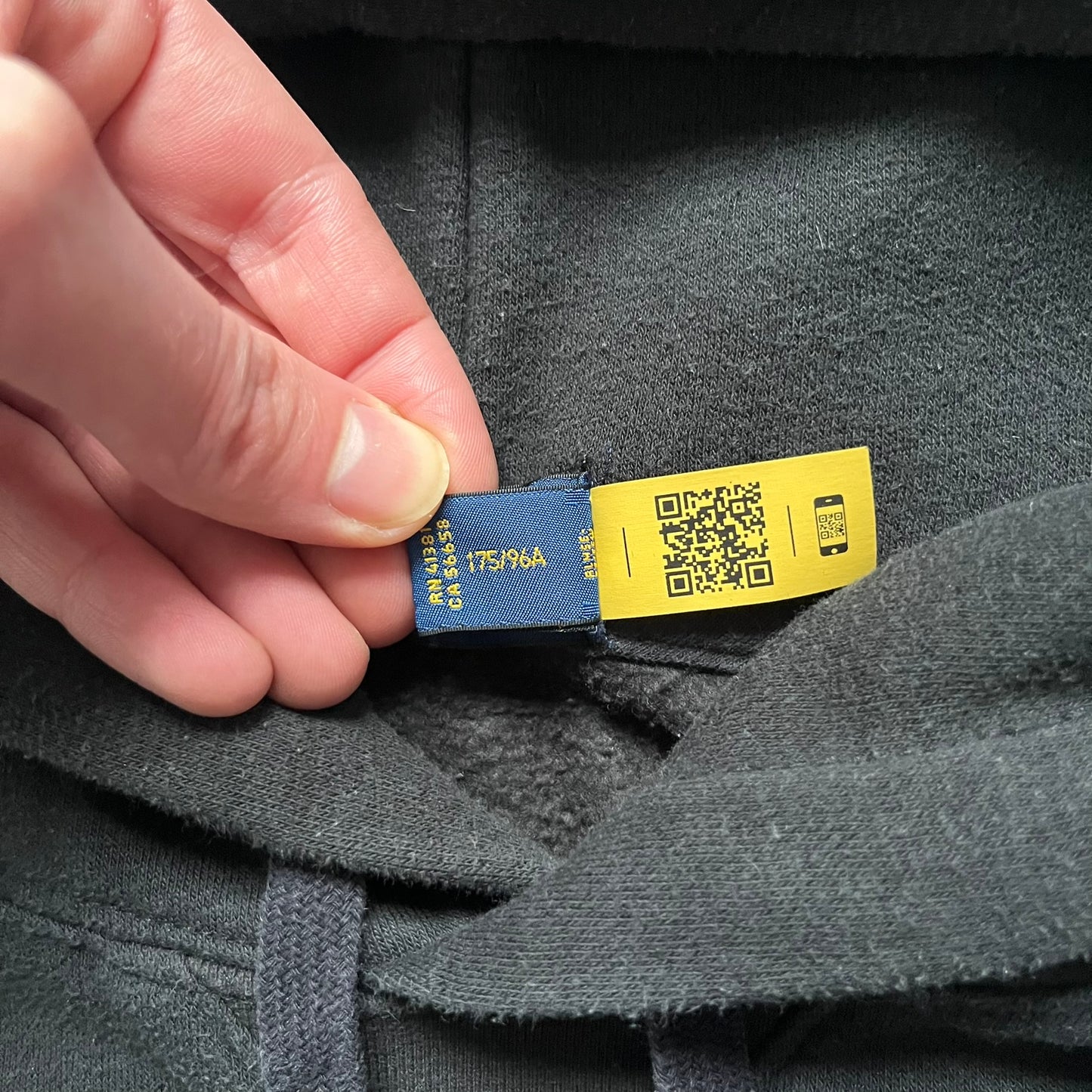 Polo Ralph Lauren x Fortnite black hoodie featuring a detailed embroidered purple Fortnite llama with the RL rider logo placed on top. Made from a 66% cotton and 34% polyester blend, it has a classic pullover construction with an attached hood and front kangaroo pocket. The embroidery is positioned on the left chest and stands out with clean stitching and sharp detail.