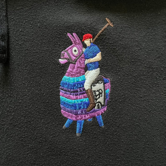  Polo Ralph Lauren x Fortnite black hoodie featuring a detailed embroidered purple Fortnite llama with the RL rider logo placed on top. Made from a 66% cotton and 34% polyester blend, it has a classic pullover construction with an attached hood and front kangaroo pocket. The embroidery is positioned on the left chest and stands out with clean stitching and sharp detail.