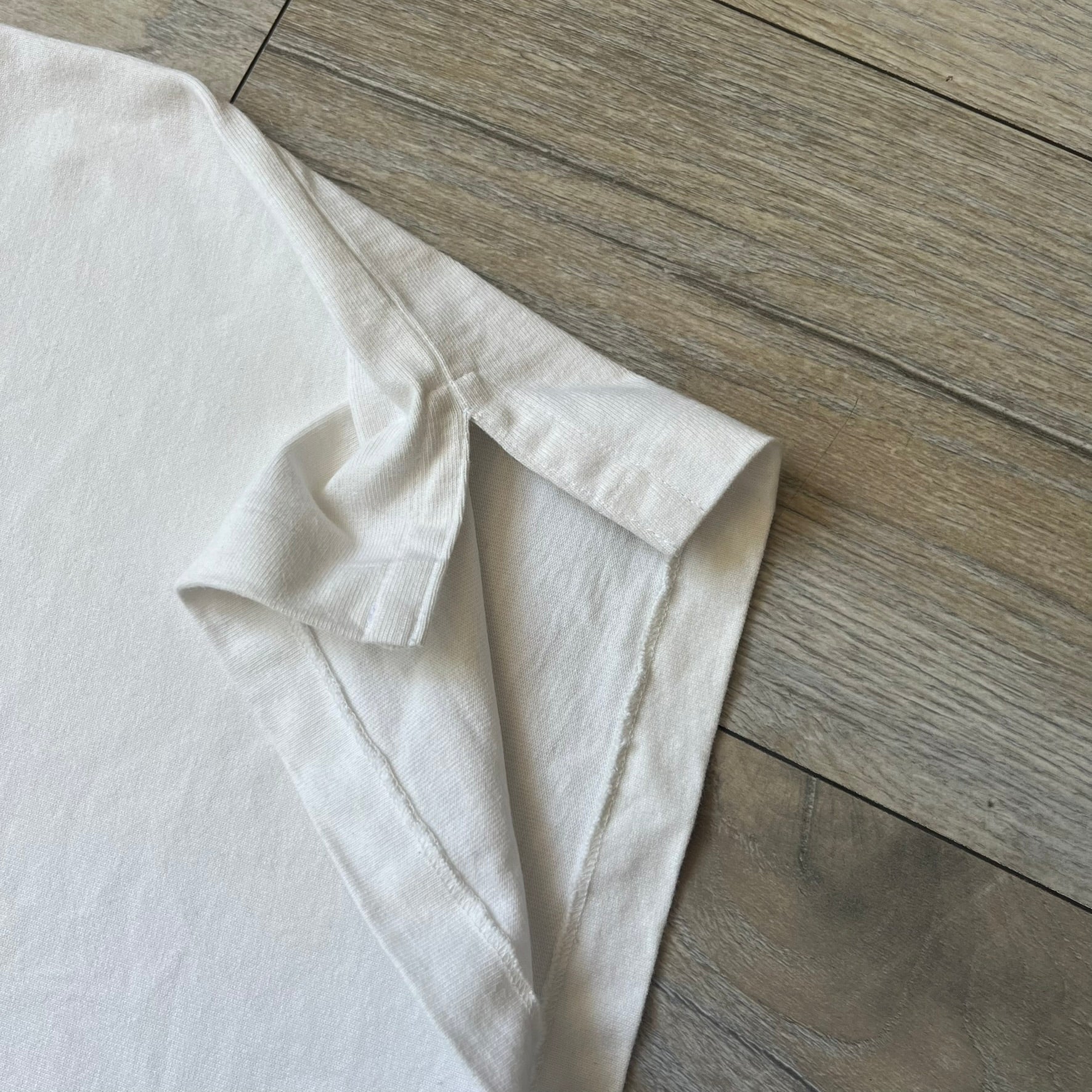 Polo Ralph Lauren “Skull &amp; Crossbone” Rugby Polo is a white short-sleeve polo made from 100% cotton. It features a black contrasting rugby-style collar and a three-button placket. On the chest is a black embroidered skull and crossbones design with “1923” below it and “R.L.F.C” above. The design includes a split hem and embroidered detailing on the front.