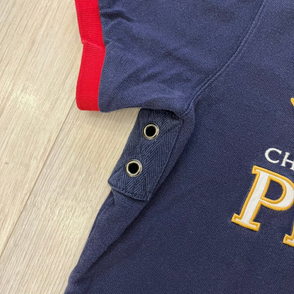 Ralph Lauren’s “PRL Club” Big Pony Polo stands out with detailed front embroidery, combining a Big Pony motif, Challenge Cup text, and a large crest. The navy body is paired with red accents on the collar and sleeves, with a signature oversized “3” and PRL Club branding on the back.