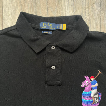 Polo Ralph Lauren x Fortnite 2022 Embroidered Llama Polo is a black cotton polo shirt from the 2022 collaboration collection. It features a classic fit with a two-button collar design and an embroidered chest logo replacing the traditional Ralph Lauren horse with the iconic Fortnite llama in purple and blue tones. Made from 100% cotton.