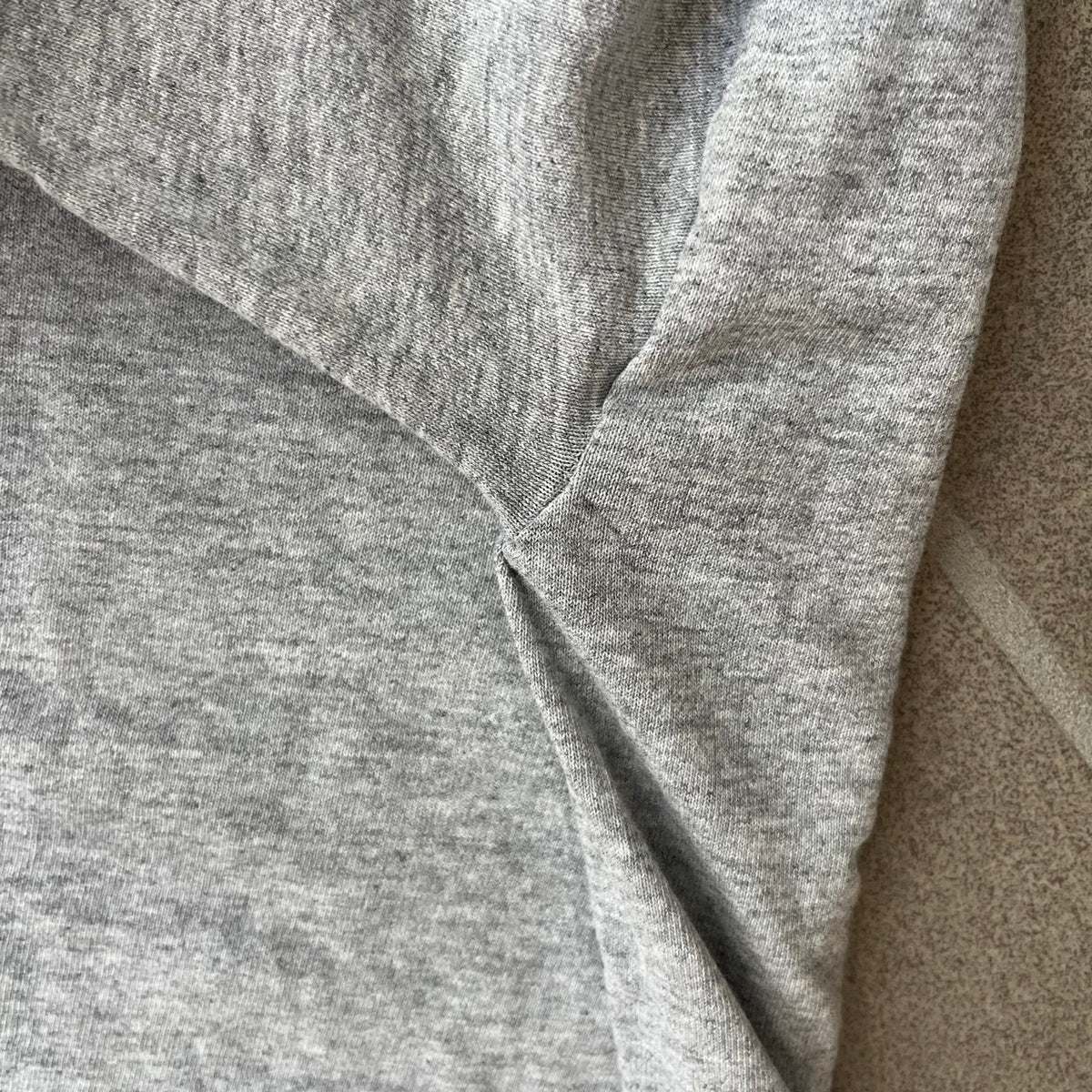 Porn Star Clothing 90's Fruits Gray Tee features a grey T-shirt with an apple, banana, and pear graphic on the chest, arranged as a you know what. A small Porn Star logo is printed underneath, with the “Good Clothing for Bad People” branding on the neck tag. The shirt has two professionally repaired holes under the armpits.