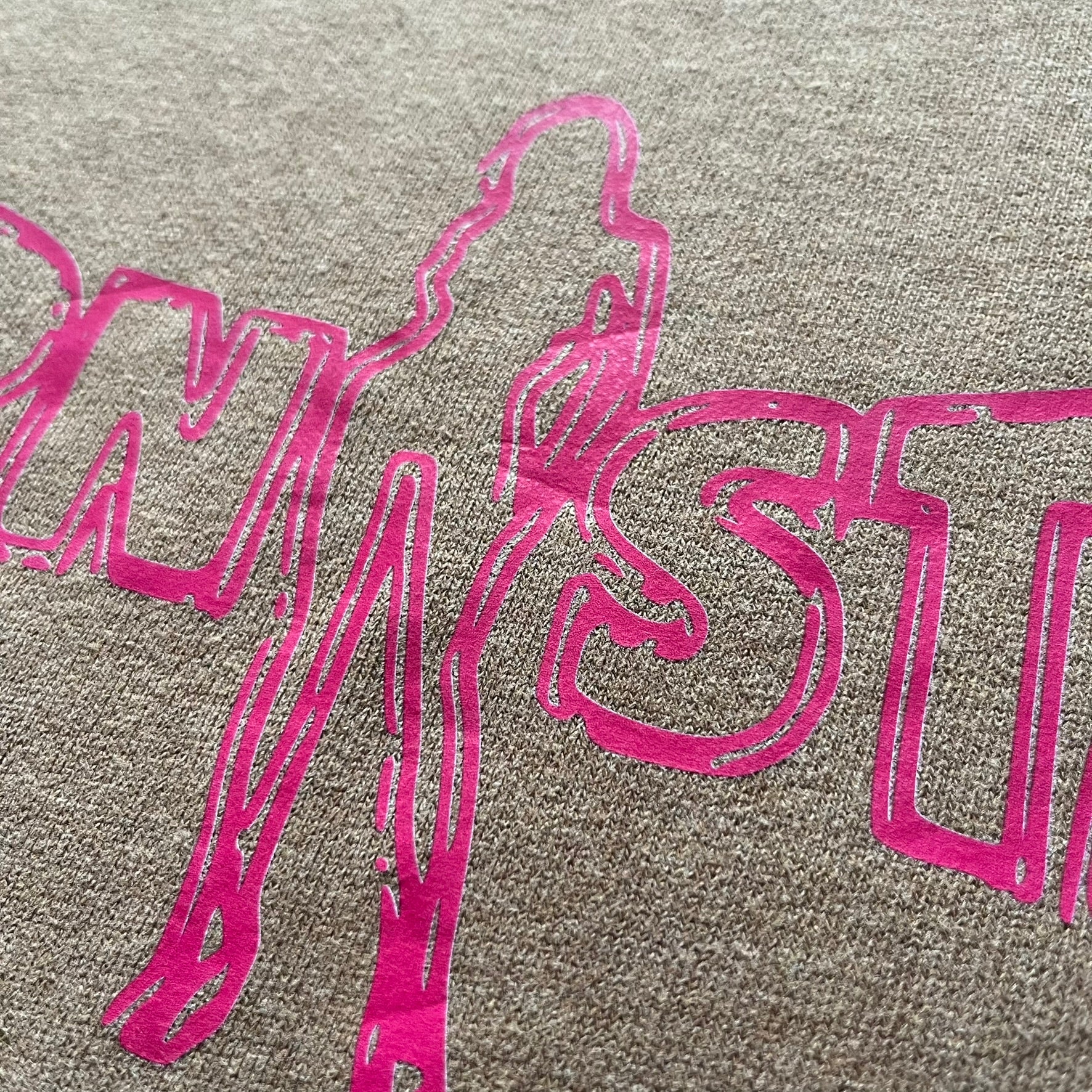 Vintage 90’s Porn Star Clothing longsleeve in brown, featuring a bold pink logo on the chest with a silhouette outline of a woman between the words “Porn” and “Star.” Crafted with quality construction, it carries the brand’s signature edgy aesthetic. Finished with a playful “must be 18 or over” detail on the tag, this rare piece embodies 90’s streetwear provocative style.