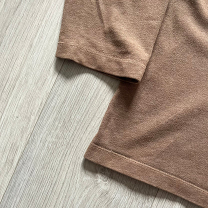 Vintage 90’s Porn Star Clothing longsleeve in brown, featuring a bold pink logo on the chest with a silhouette outline of a woman between the words “Porn” and “Star.” Crafted with quality construction, it carries the brand’s signature edgy aesthetic. Finished with a playful “must be 18 or over” detail on the tag, this rare piece embodies 90’s streetwear provocative style.
