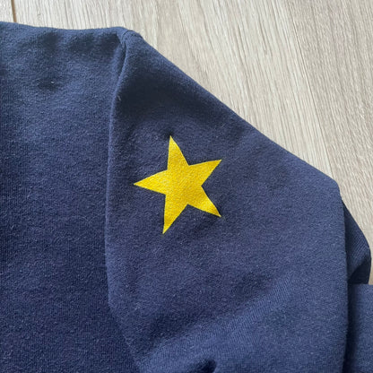 Navy blue fabric with a yellow star on a wooden surface