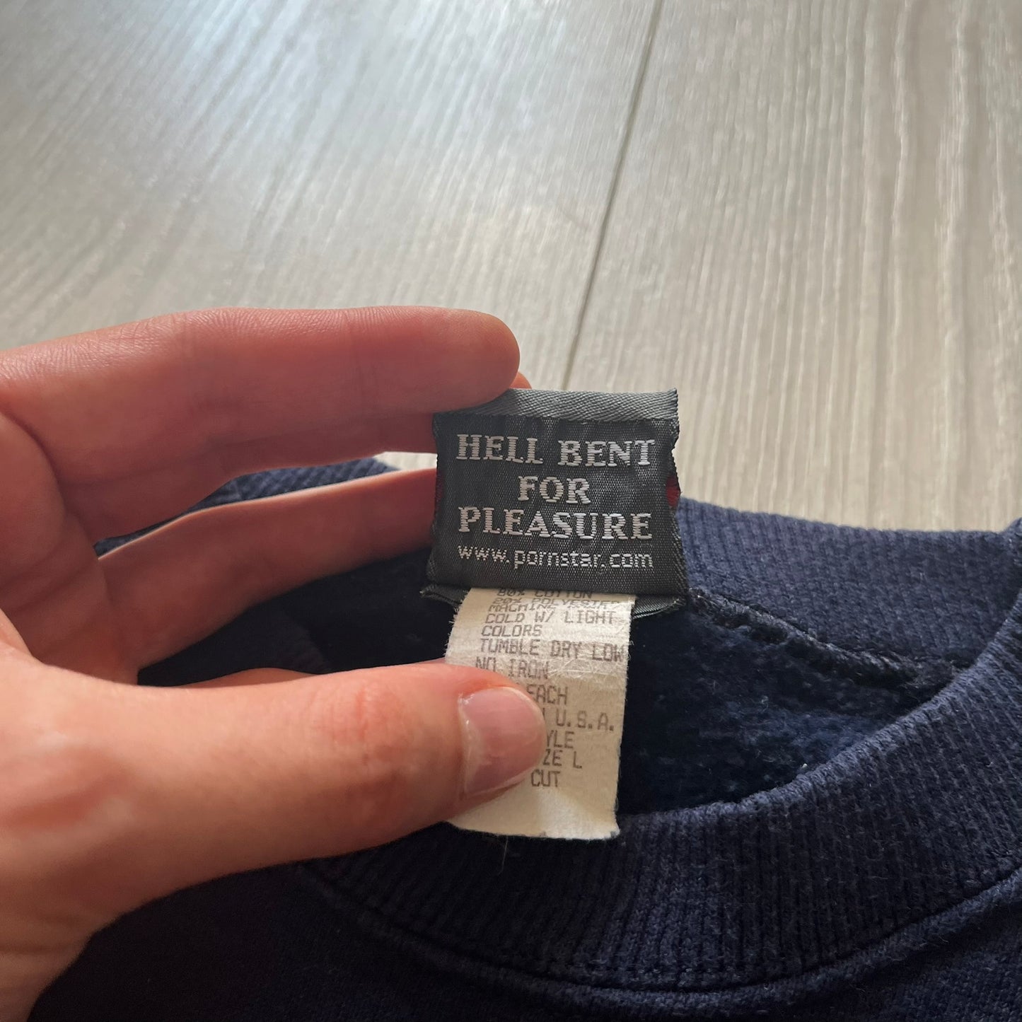 Close-up of a label on a piece of clothing with text.