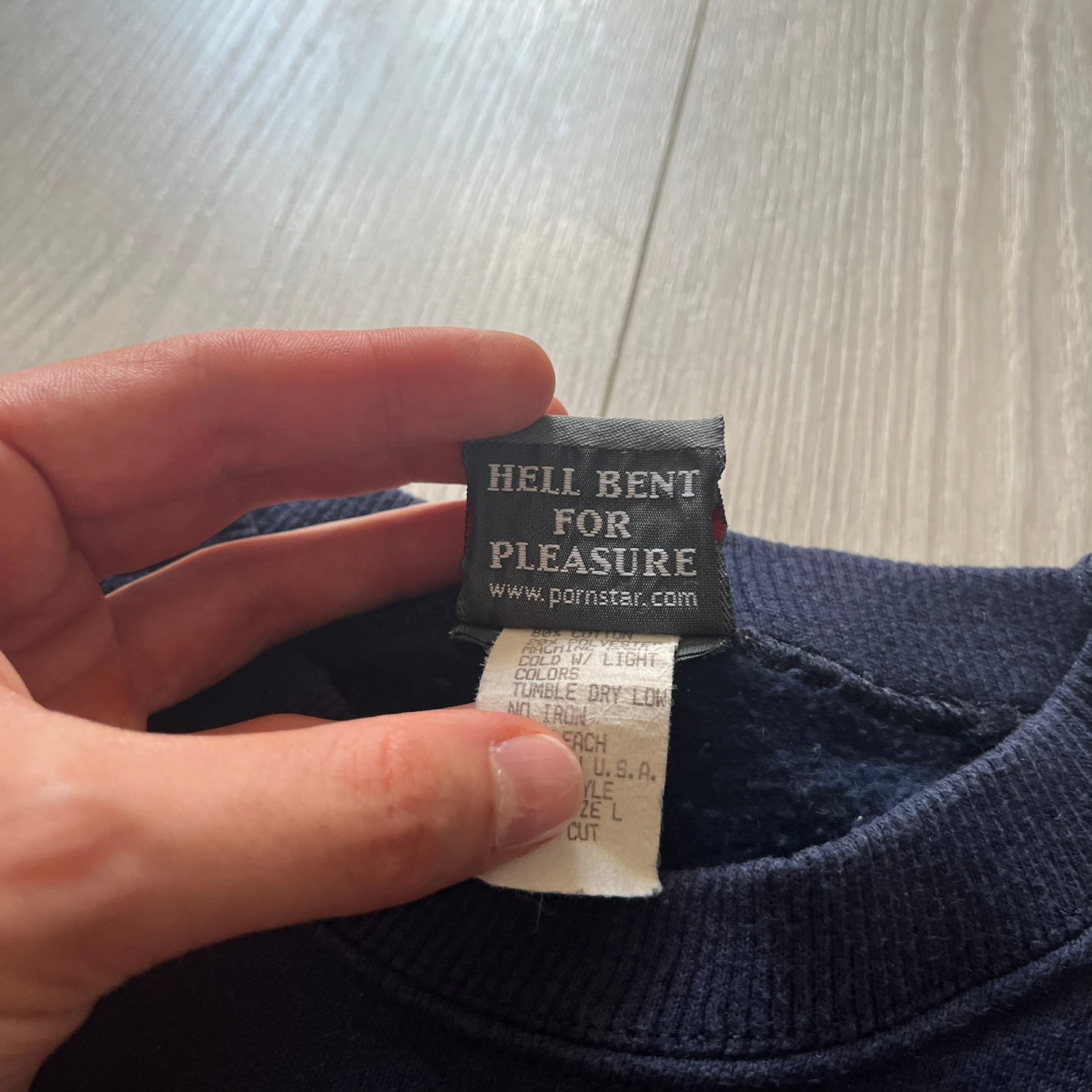 Close-up of a label on a piece of clothing with text.