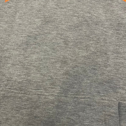 Porn Star Clothing Thrasher Hoodie from the 1990s, made in a gray cotton fabric. The front features a large flame-style “Pornstar” logo that is a spin-off of the Trasher one, with matching flame graphics running down both sleeves. Designed with an adjustable drawstring hood, front kangaroo pocket, and ribbed cuffs and hem. Finished with the original “Must Be 18 Or Over” Porn Star Clothing tag.