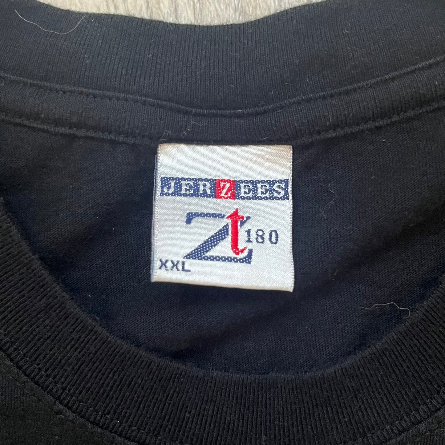 PornoRalle TV 1990s Black Tee is a black short-sleeve T-shirt made on a Jerzees blank. The front features a white PornoRalle logo on the chest with small “TV Total” text beneath. This minimalist design dates from the 1990s.