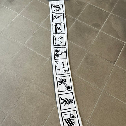 Portal 2 Chamber Squares 2015 Knit Scarf features a reversible design. One side is grey with an Aperture Laboratories logo in the center, along with two portals containing Atlas and P-body, one blue and one orange. The other side is white with a repeating pattern of Portal 2 chamber squares. Made by The Coop in 2015.