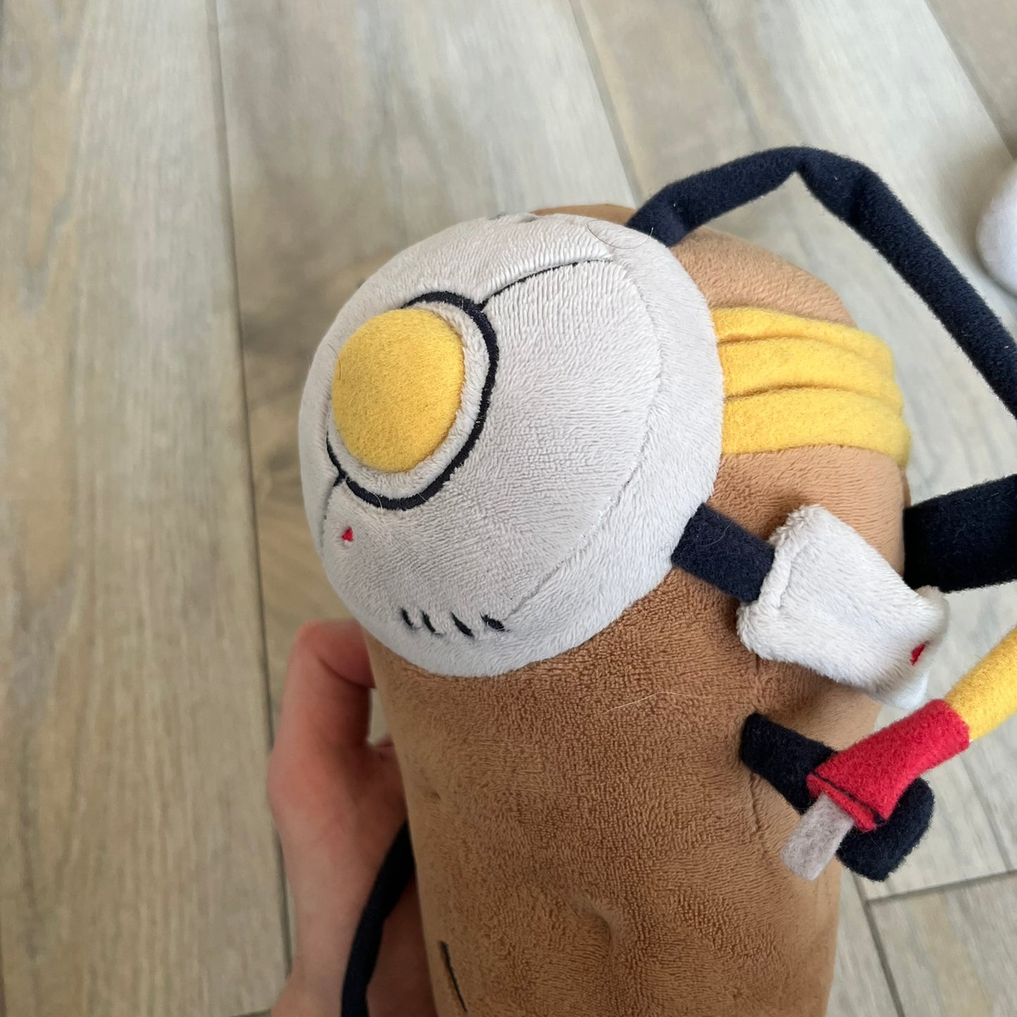 Portal 2 GLaDOS PotatOS 2013 ThinkGeek Talking Plush is a collectible plush toy based on the PotatOS version of GLaDOS from the Portal 2 video game. The plush features a soft construction with integrated electronics, including 10 pre-recorded voice lines activated by a button, along with a light-up eye effect. It requires 3 AA batteries (not included), includes an on/off switch hidden in the back compartment, and was produced by ThinkGeek in 2013.