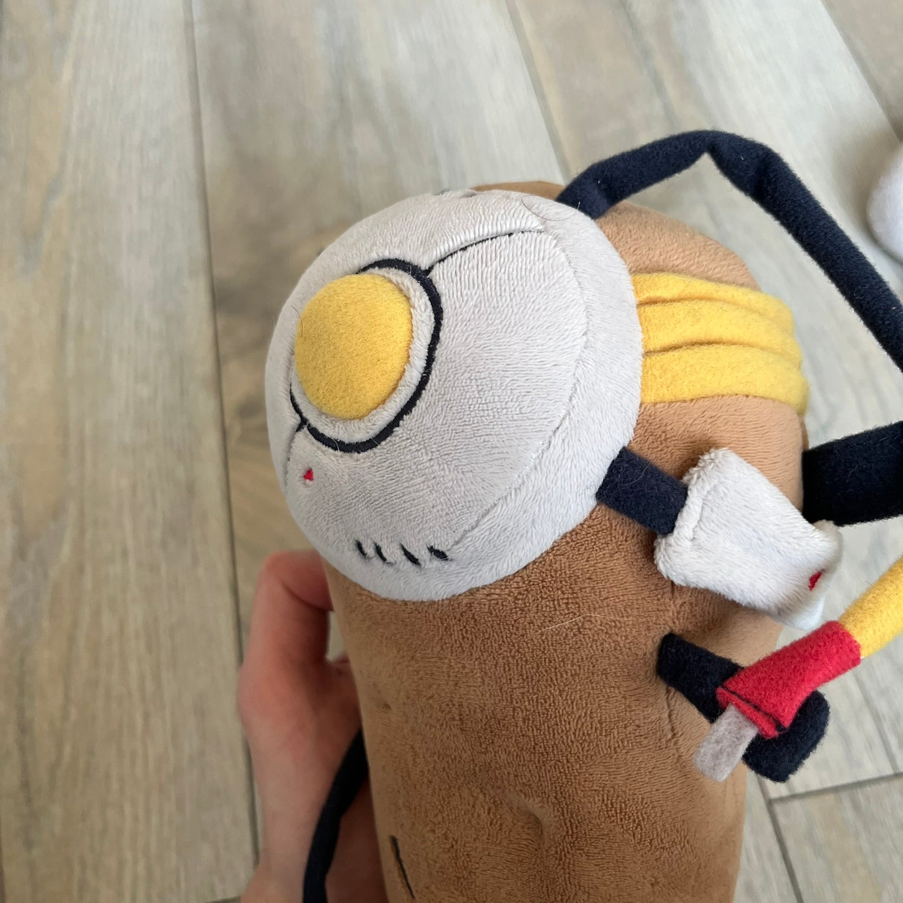 Portal 2 GLaDOS PotatOS 2013 ThinkGeek Talking Plush is a collectible plush toy based on the PotatOS version of GLaDOS from the Portal 2 video game. The plush features a soft construction with integrated electronics, including 10 pre-recorded voice lines activated by a button, along with a light-up eye effect. It requires 3 AA batteries (not included), includes an on/off switch hidden in the back compartment, and was produced by ThinkGeek in 2013.