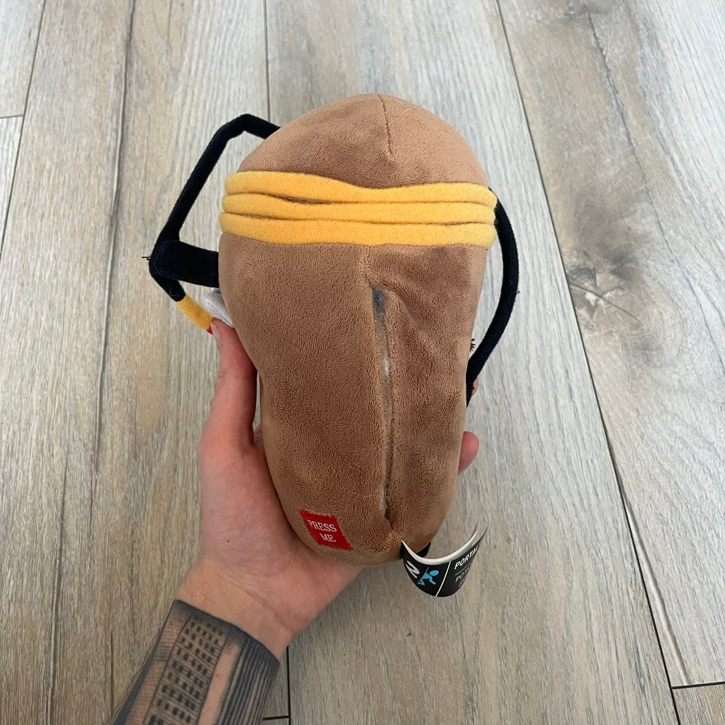 Portal 2 GLaDOS PotatOS 2013 ThinkGeek Talking Plush is a collectible plush toy based on the PotatOS version of GLaDOS from the Portal 2 video game. The plush features a soft construction with integrated electronics, including 10 pre-recorded voice lines activated by a button, along with a light-up eye effect. It requires 3 AA batteries (not included), includes an on/off switch hidden in the back compartment, and was produced by ThinkGeek in 2013.