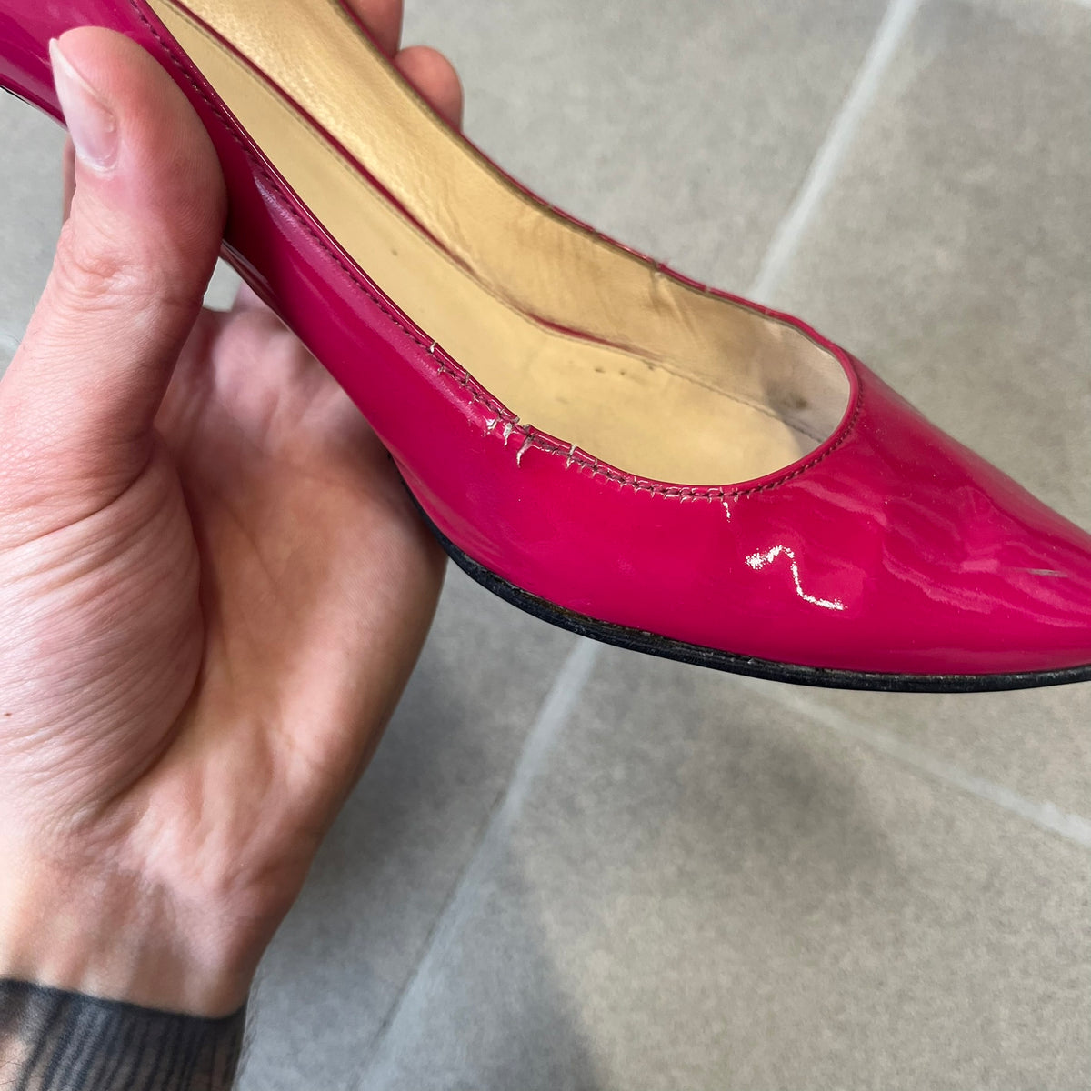 Prada 2000's Patent Leather Magenta Kitten Heels are made in Italy from magenta patent leather with a beige interior and sole, featuring a gold-tone metal Prada logo on the bottom and Prada branding on the insole. They come with the original box and two dust bags; the bottom and heel tip have been professionally repaired.