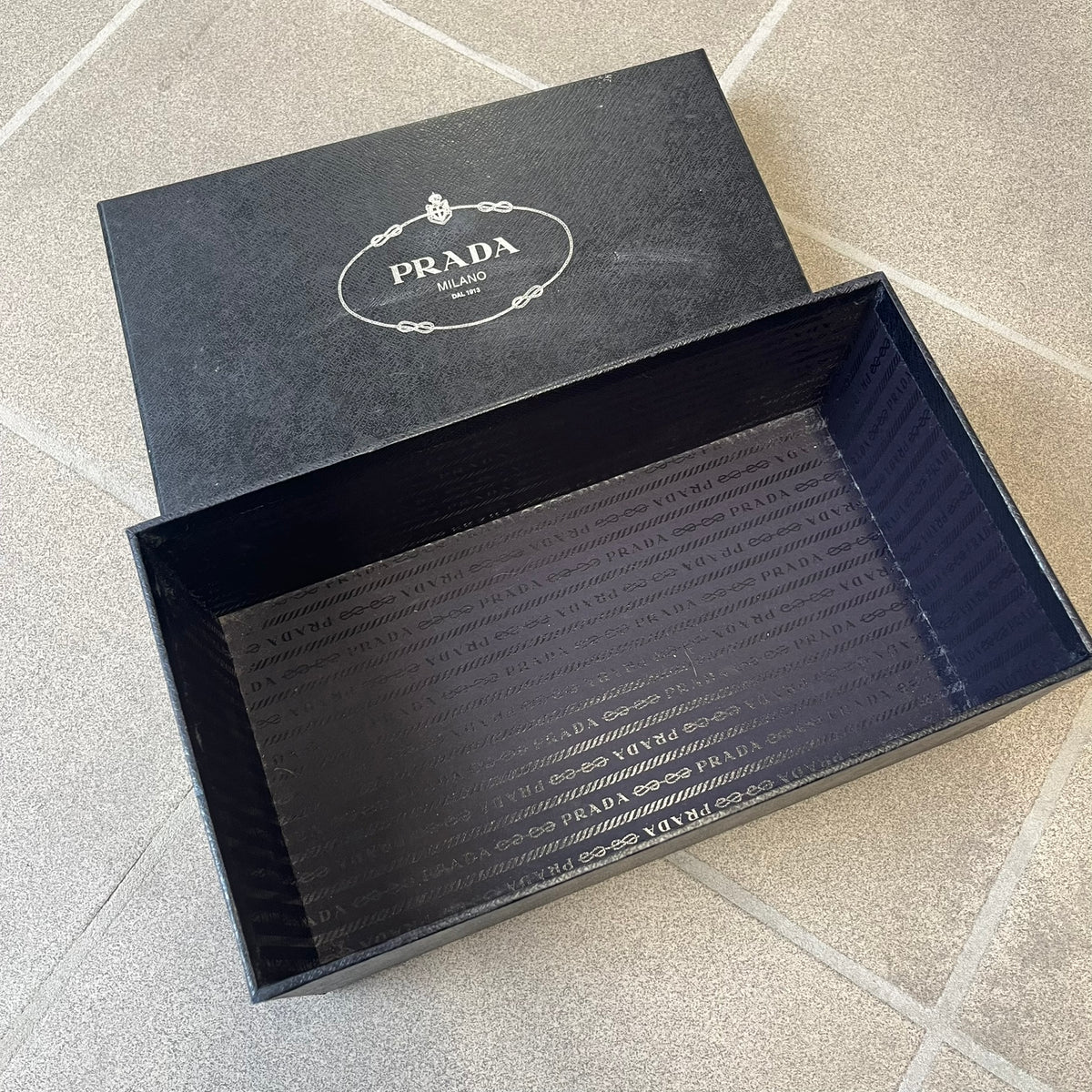 Prada 2000's Patent Leather Magenta Kitten Heels are made in Italy from magenta patent leather with a beige interior and sole, featuring a gold-tone metal Prada logo on the bottom and Prada branding on the insole. They come with the original box and two dust bags; the bottom and heel tip have been professionally repaired.