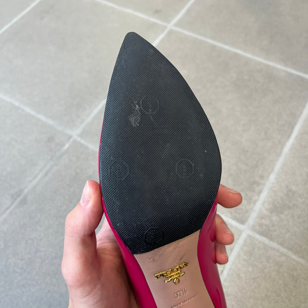 Prada 2000's Patent Leather Magenta Kitten Heels are made in Italy from magenta patent leather with a beige interior and sole, featuring a gold-tone metal Prada logo on the bottom and Prada branding on the insole. They come with the original box and two dust bags; the bottom and heel tip have been professionally repaired.