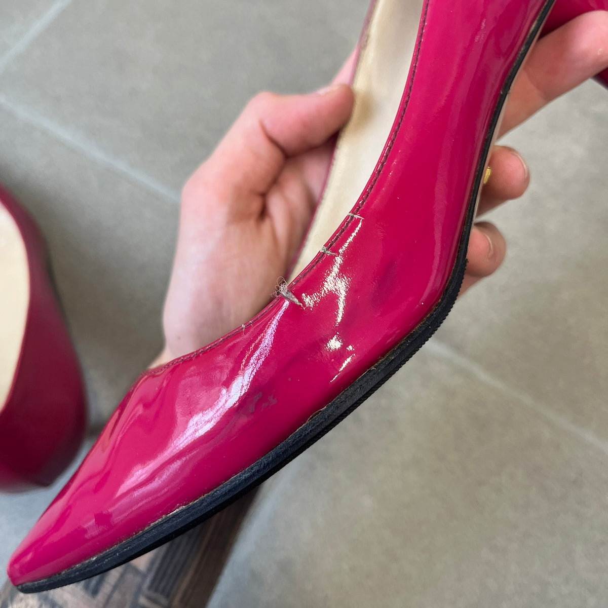 Prada 2000's Patent Leather Magenta Kitten Heels are made in Italy from magenta patent leather with a beige interior and sole, featuring a gold-tone metal Prada logo on the bottom and Prada branding on the insole. They come with the original box and two dust bags; the bottom and heel tip have been professionally repaired.