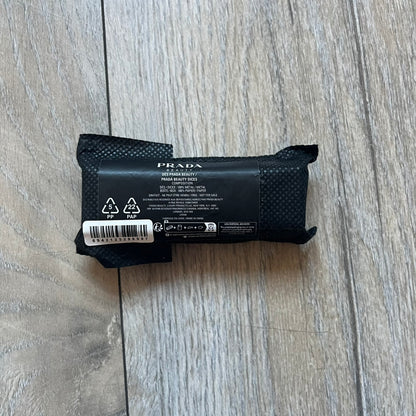 Prada Gold and Silver Dice Set consisting of five metal dice, including two gold-tone and three silver-tone pieces (color finish, not solid gold or silver). Each die is fully metal and has the Prada logo engraved on the face with the number one. The set was released in limited quantities as a promotional addition to Prada fragrances and comes with a Prada Beauty paper box