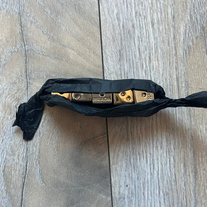 Prada Gold and Silver Dice Set consisting of five metal dice, including two gold-tone and three silver-tone pieces (color finish, not solid gold or silver). Each die is fully metal and has the Prada logo engraved on the face with the number one. The set was released in limited quantities as a promotional addition to Prada fragrances and comes with a Prada Beauty paper box