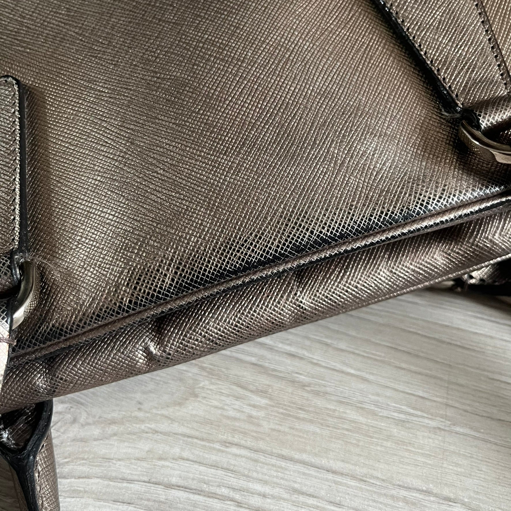 Vintage Prada Metallic Saffiano Bauletto Bag crafted from metallic gold saffiano leather embodies vintage elegance and modern luxury. Detailed with gold-tone hardware, dual handles, and original accessories, it’s a testament to Prada’s enduring craftsmanship. A collector’s piece made to shine on any occasion.