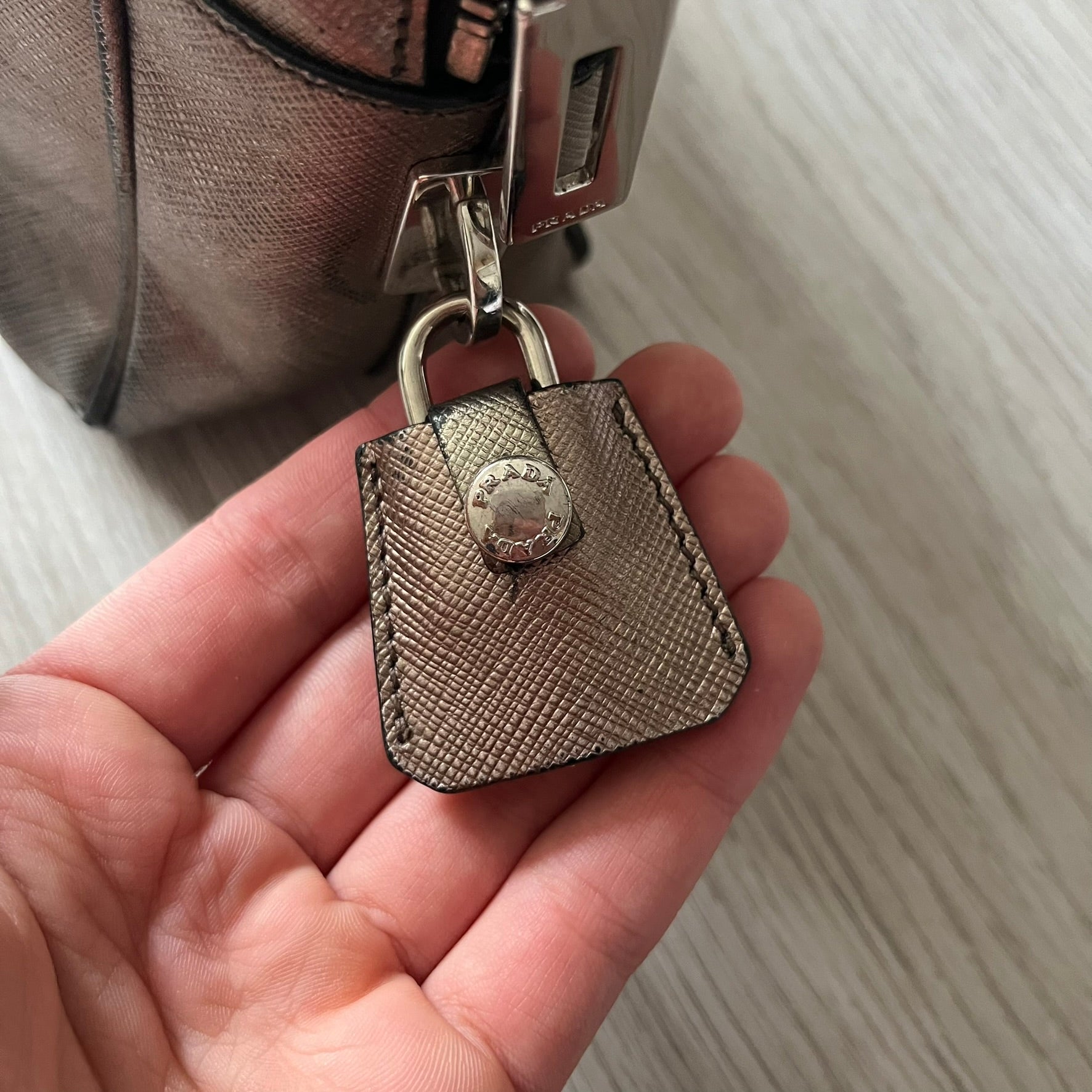 Vintage Prada Metallic Saffiano Bauletto Bag crafted from metallic gold saffiano leather embodies vintage elegance and modern luxury. Detailed with gold-tone hardware, dual handles, and original accessories, it’s a testament to Prada’s enduring craftsmanship. A collector’s piece made to shine on any occasion.