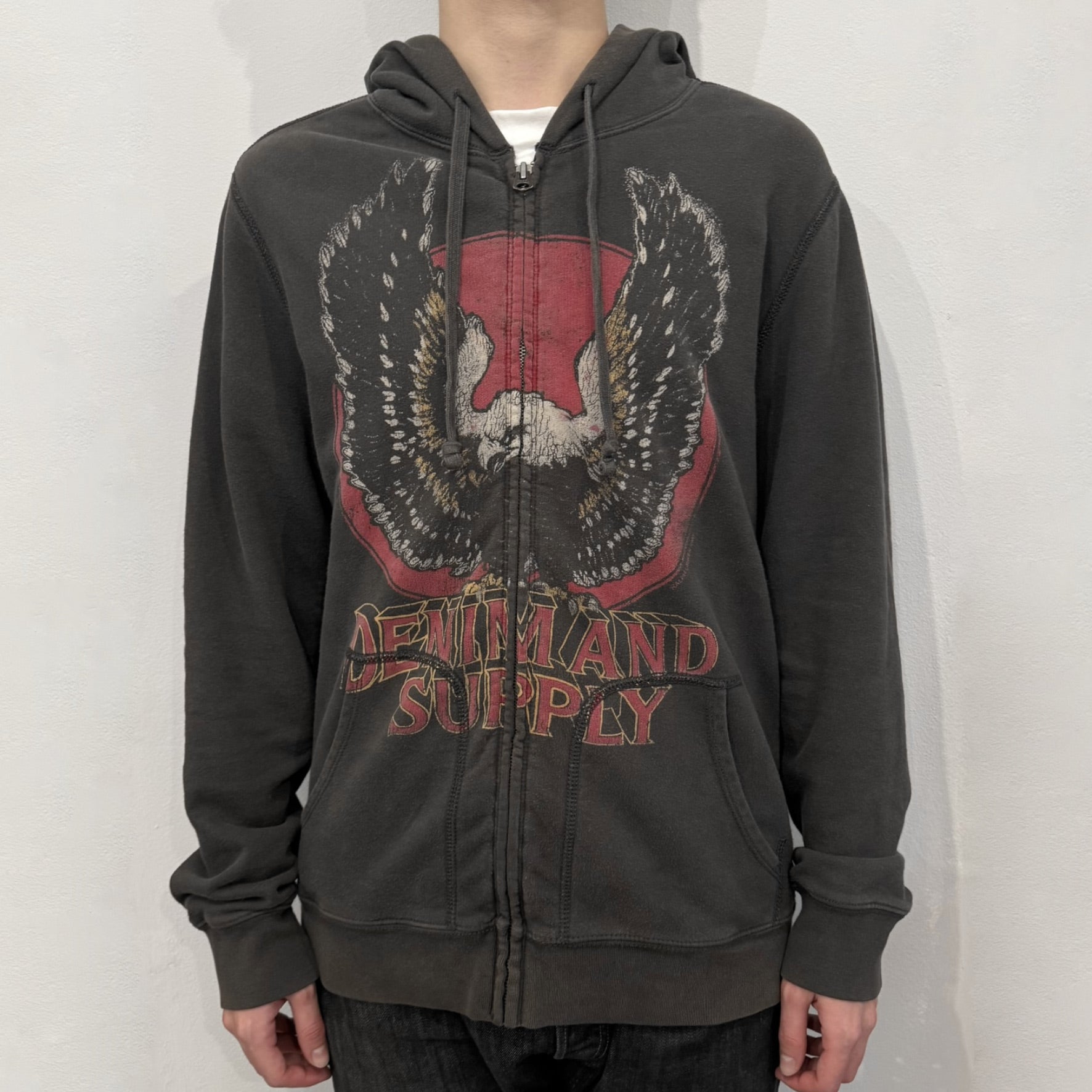 Ralph Lauren Denim &amp; Supply Eagle Hoodie in dark brown, featuring a big front graphic with a large eagle over a filled red circle. The design is completed with prominent red “Denim and Supply” under the graphic. From the discontinued Denim &amp; Supply line.