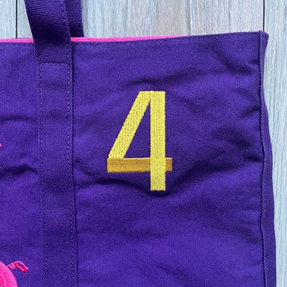Ralph Lauren Purple &amp; Pink 4 thick tote bag with a large pink embroidered RL horse logo on the front. Yellow number "4" on the upper right. Interior is pink, made from a softer, smooth material. High-quality embroidery and sturdy exterior construction.