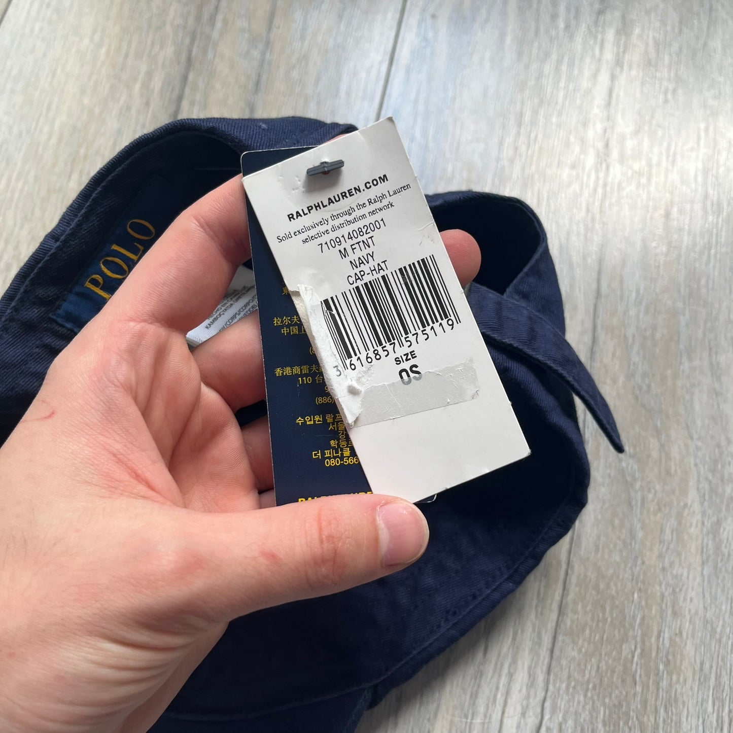 Ralph Lauren x Fortnite Navy Logo Baseball Cap is a navy cotton cap featuring bold embroidered branding on the front, including red Polo Ralph Lauren text and a Fortnite logo patch combined with a USA Ralph Lauren crest. The back includes a white embroidered Ralph Lauren logo and an adjustable strap for a custom fit.