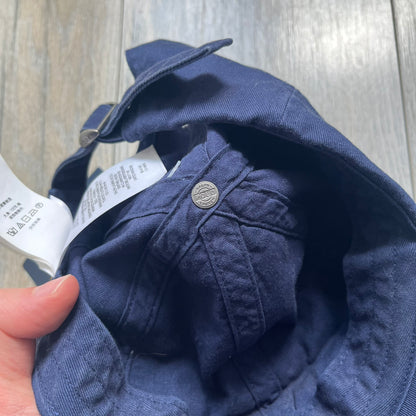 Ralph Lauren x Fortnite Navy Logo Baseball Cap is a navy cotton cap featuring bold embroidered branding on the front, including red Polo Ralph Lauren text and a Fortnite logo patch combined with a USA Ralph Lauren crest. The back includes a white embroidered Ralph Lauren logo and an adjustable strap for a custom fit.