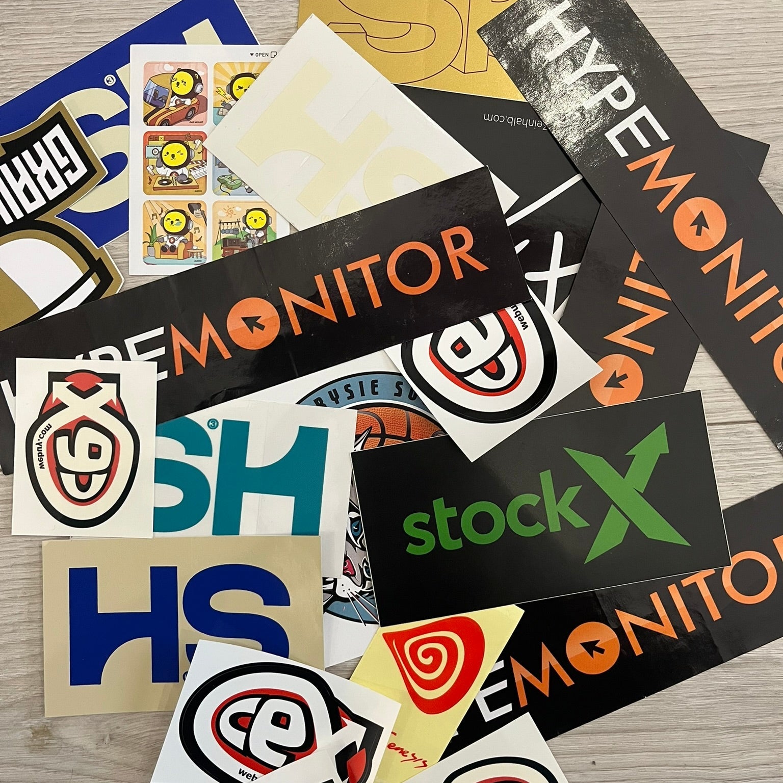 A collection of various stickers including brand logos and abstract designs.