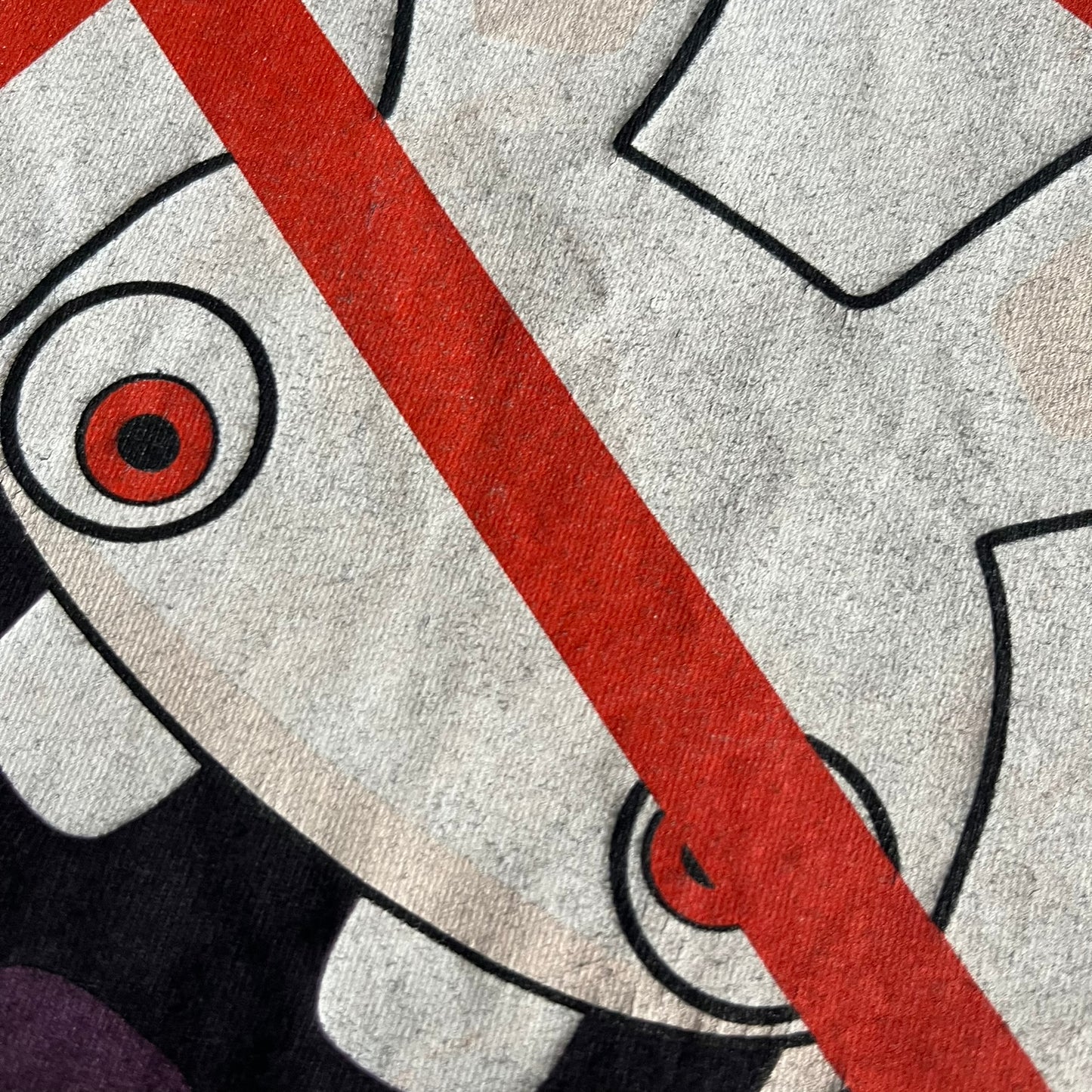 Raving Rabbids - known as “Lapins Crétins” in France - 2010 Tee in black, features a white Rabbid head inside a red circle with a slash, similar to a forbidden symbol. Officially licensed by Ubisoft, it comes with branding tags for collector and fan authenticity.&nbsp;