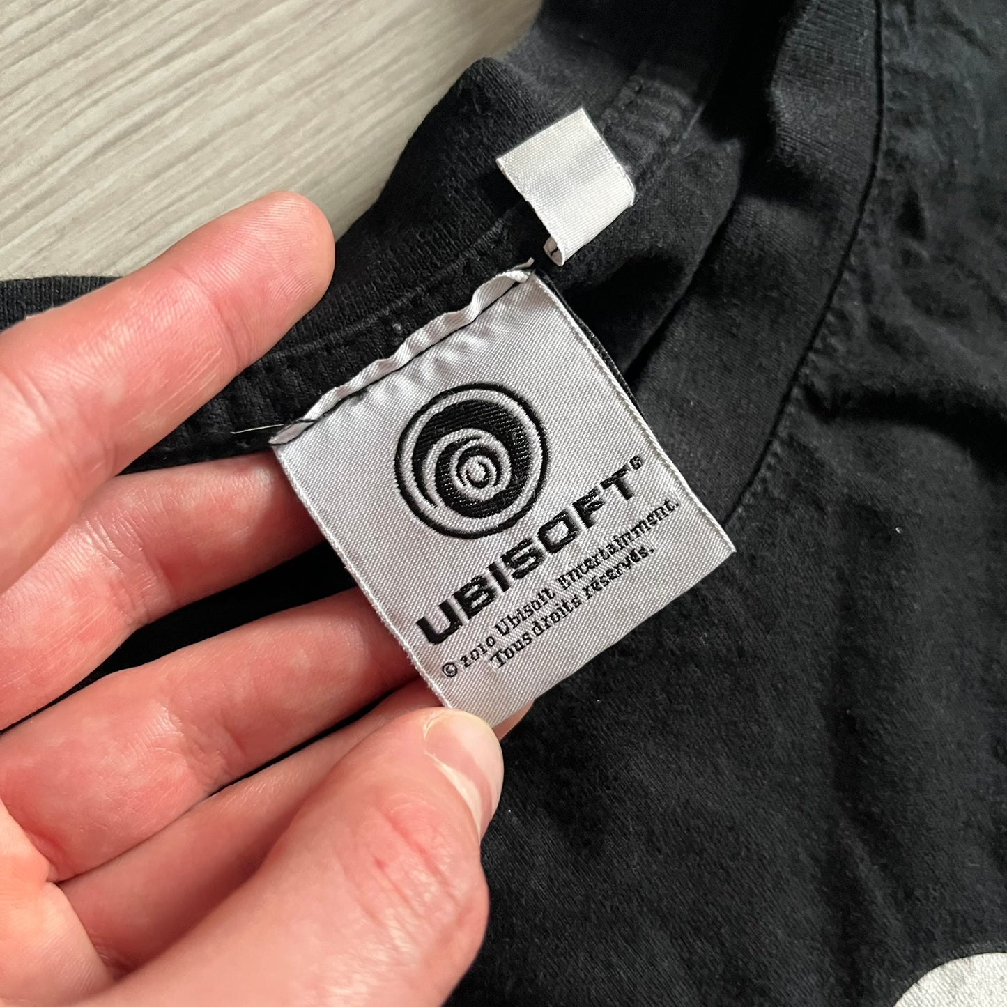 Raving Rabbids - known as “Lapins Crétins” in France - 2010 Tee in black, features a white Rabbid head inside a red circle with a slash, similar to a forbidden symbol. Officially licensed by Ubisoft, it comes with branding tags for collector and fan authenticity.&nbsp;