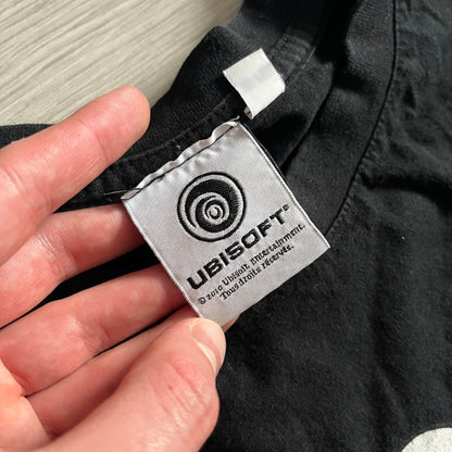 Raving Rabbids - known as “Lapins Crétins” in France - 2010 Tee in black, features a white Rabbid head inside a red circle with a slash, similar to a forbidden symbol. Officially licensed by Ubisoft, it comes with branding tags for collector and fan authenticity.&nbsp;