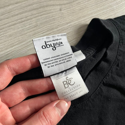 Raving Rabbids - known as “Lapins Crétins” in France - 2010 Tee in black, features a white Rabbid head inside a red circle with a slash, similar to a forbidden symbol. Officially licensed by Ubisoft, it comes with branding tags for collector and fan authenticity.&nbsp;