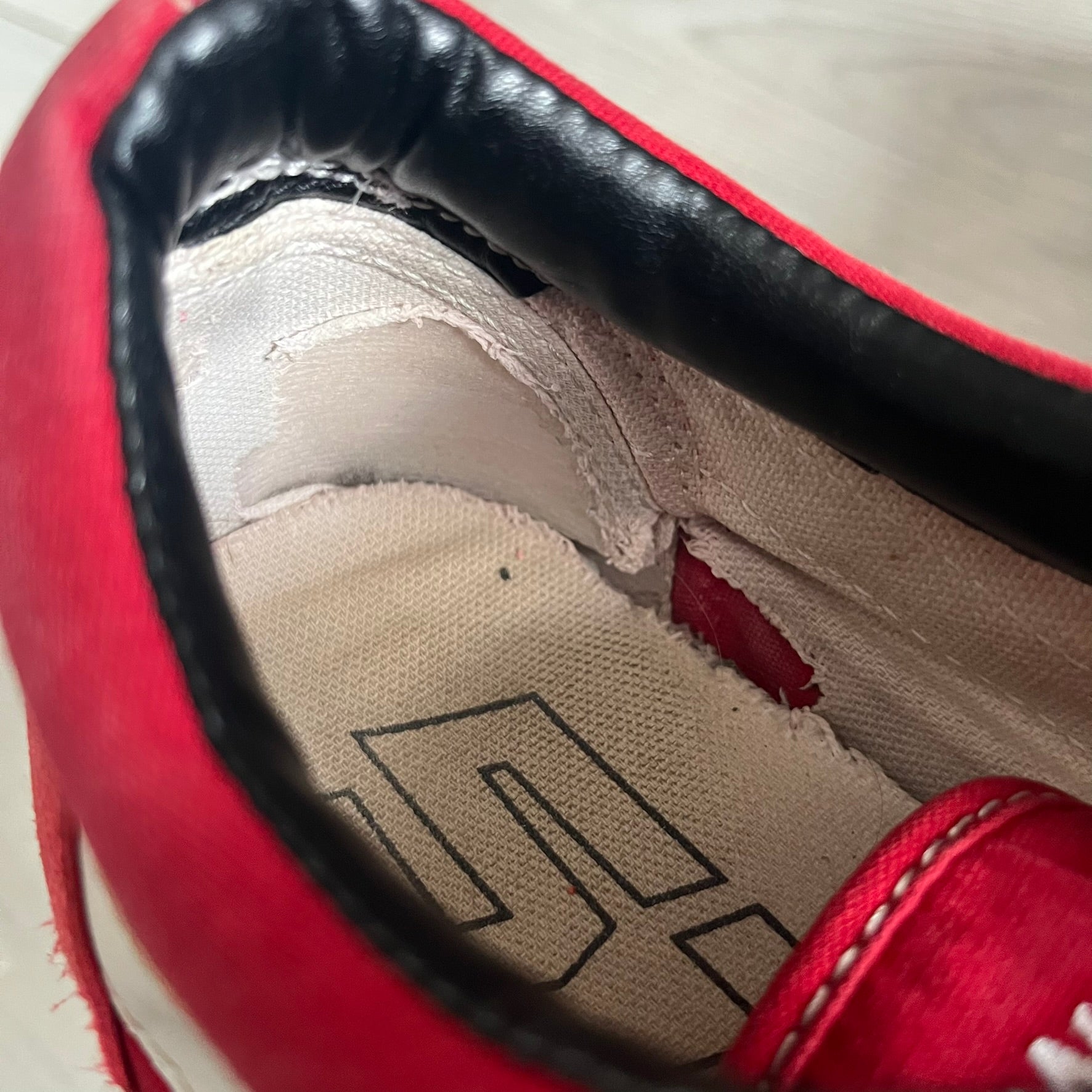 Revenge x Storm Red Strap Sneakers designed by Ian Connor. Featuring a red upper with white leather lightning bolts replacing the traditional Vans stripe. Finished with Velcro strap closures, white midsoles, black outsoles, and the signature “Revenge x Storm” branding in red on the sole.