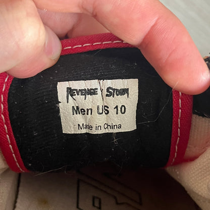 Revenge x Storm Red Strap Sneakers designed by Ian Connor. Featuring a red upper with white leather lightning bolts replacing the traditional Vans stripe. Finished with Velcro strap closures, white midsoles, black outsoles, and the signature “Revenge x Storm” branding in red on the sole.