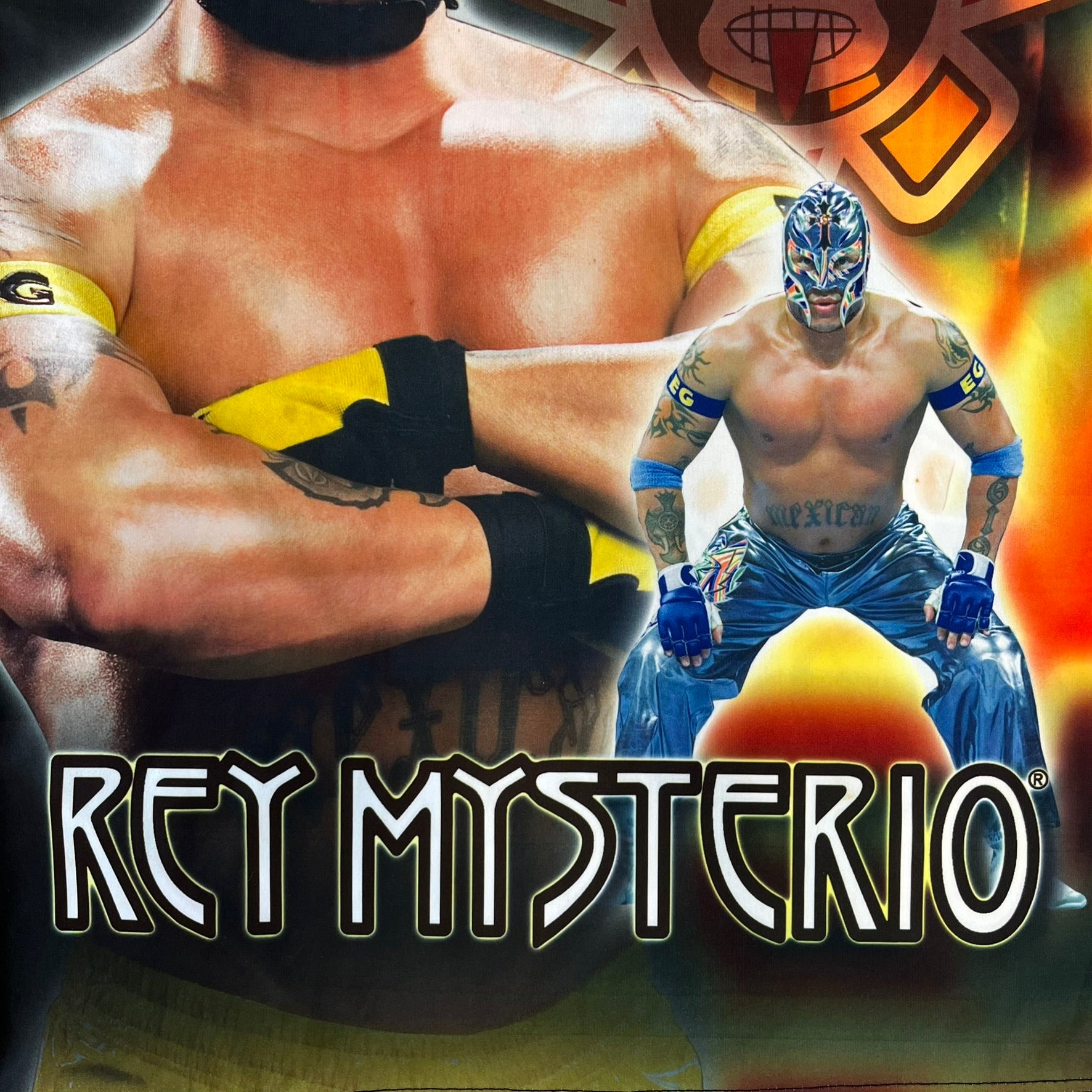 Rey Mysterio 2007 Kalciomania AOP Tee features an all-over print design with red, black, and white graphics throughout. The front includes a Rey Mysterio graphic with “Rey Mysterio” text, WWE logos, and additional printed details. The back features Rey Mysterio wearing a white mask with his signature and “619” graphic. The sleeves include a WWE logo and Rey Mysterio branding. Finished with a Kalciomania licensed tag.
