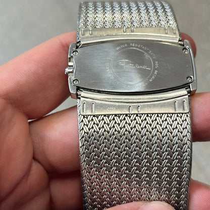 Roberto Cavalli 2000's Ellisse Analog Watch features a curved silver-tone case with a textured mesh bracelet and adjustable strap. The dial has a pearlescent finish that changes slightly depending on the angle, with no hour numbers and a small Roberto Cavalli logo at the bottom.
