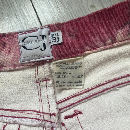 Roberto Cavalli Pink Floral 2000’s Jeans are made in Italy from 98% cotton and 2% elastane. The jeans feature an all-over floral print in multiple shades of pink, ranging from light to dark, with a hand-painted effect across the fabric. Details include branded buttons, a leather logo tab at the back, and classic five-pocket construction with two front and two back pockets.