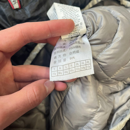 Roberto Cavalli Sport 2010's Black Lightweight Jacket is a lightweight hooded jacket in black with a gray interior, featuring two front pockets and star logo zipper pulls. A rubber Roberto Cavalli Sport logo patch sits on the chest, with a smaller matching patch on the upper back.