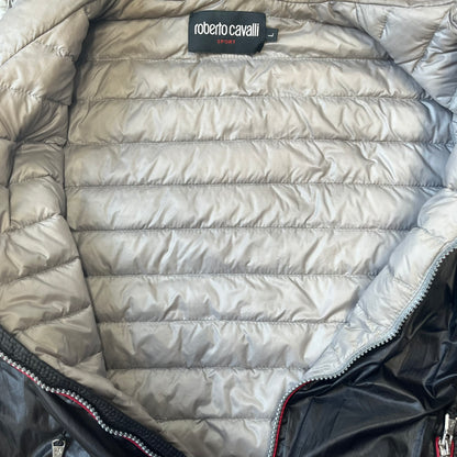 Roberto Cavalli Sport 2010's Black Lightweight Jacket is a lightweight hooded jacket in black with a gray interior, featuring two front pockets and star logo zipper pulls. A rubber Roberto Cavalli Sport logo patch sits on the chest, with a smaller matching patch on the upper back.