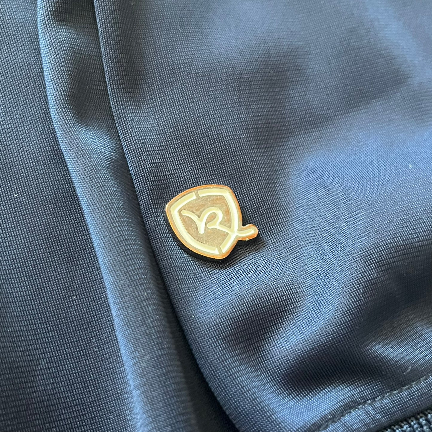Rocawear Dark Navy Vintage Track Jacket, featuring a small embroidered logo on the chest and a large white logo across the back, finished with a silver emblem near the wrist and a detailed silver zipper.