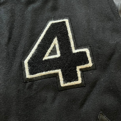 Rocawear black bomber jacket detailed with multiple statement patches, including “R” and “W” on the shoulders, a Rocawear logo with a “4” on the chest, and a large text logo across the back. Crafted with great detailing, it reflects the brand’s early 2000s streetwear identity.